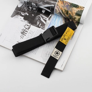 Black canvas tactical belt with yellow patch and plastic buckle on fashion magazine
