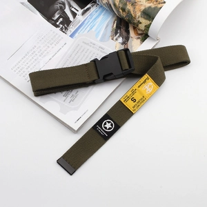 Close-up of olive green tactical nylon belt with black plastic buckle and yellow label