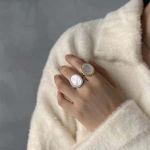 Detail of vintage oval rings with mother of pearl inlay in gold and silver finish