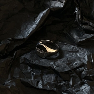 Macro detail of 925 silver adjustable signet ring with engraved Wonderful lettering