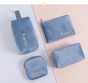 Detail view of 4-piece blue velvet cosmetic bag set with golden embroidery
