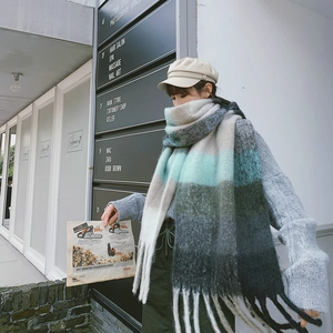 Detailed view of heavy rainbow check scarf with chunky tassels and pastel color blocking