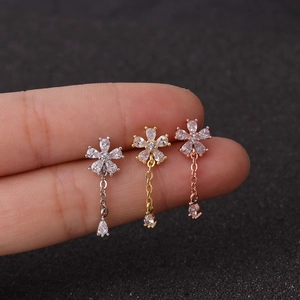 Three zircon flower earrings with droplet pendants in silver, gold, and rose gold