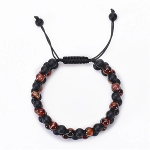 Detail of double-layer woven bracelet with matte black beads and tiger eye stones