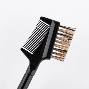 Macro detail of dual-ended eyebrow brush with fiber bristles and fine black comb
