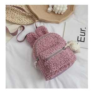 Détail du sac à dos rose en polaire avec oreilles de lapin et pendentif ours mignon