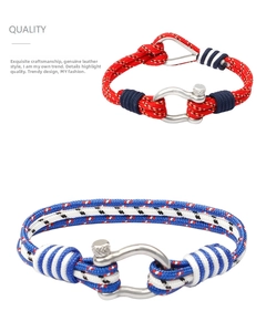 Detail of nautical paracord bracelets with metallic U-shaped shackle buckles in blue and red