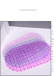 Close-up of PVC bath mat featuring purple gradient suction cups and drainage holes