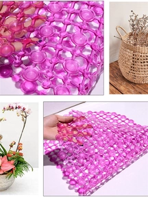 Detail of purple PVC bath mat with suction cups showing flexible grid and non-slip texture