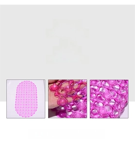Detail view of pink PVC bathroom mat showing strong suction cups and drainage holes