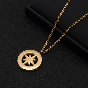 Gold-plated stainless steel necklace with octagonal star medallion on a black jewelry box