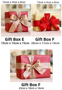 Detailed view of red and gold Christmas gift boxes with ribbons in various sizes