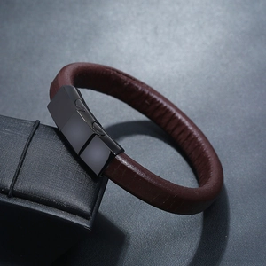 Minimalist dark brown leather bracelet with black magnetic clasp on display box