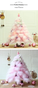 Close-up of pink feather Christmas tree with LED lights and white deer topper decor