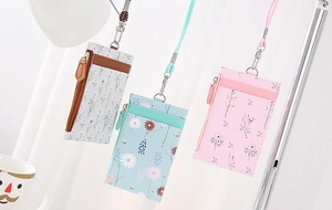 Detailed view of three PU leather badge holders with lanyards in floral patterns
