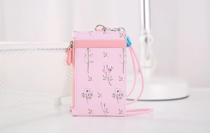 Detail of pink floral PU leather card holder with zip pocket and matching neck lanyard