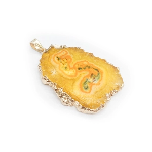 Macro shot of solar quartz slice pendant with natural textures and gold-plated metal edge