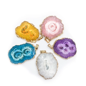 Detail of five multi-colored agate slice pendants with elegant gold plated edges