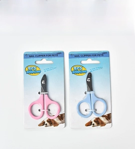 Detail view of pink and blue pet nail clippers in retail blister card packaging