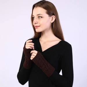 Detailed knit texture of dark brown cable-knit arm warmers and fingerless gloves