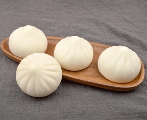 Detailed view of four realistic 7cm white steamed bun models on a rustic wooden tray