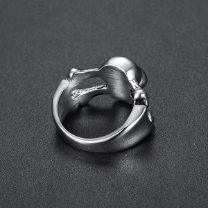 Macro shot of silver skull ring detail showing polished stainless steel finish and inner band
