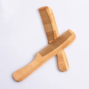 Macro detail of natural bamboo hotel combs set with fine wood grain and rounded edges