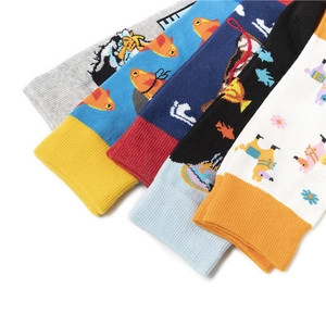 Detail shot of mid-calf socks with colorful cartoon animal prints and ribbed cuffs