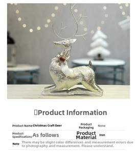 Detail of silver iron reindeer sculpture with festive scarf and red berry decorations