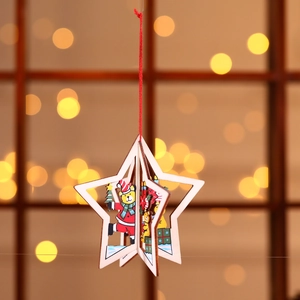 Detail of wooden star-shaped Christmas ornament with cute teddy bear and red string