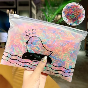 Close-up of colorful elastic hair bands in a frosted zipper pouch with cartoon bird print