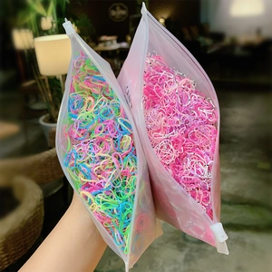 Close-up of colorful elastic hair bands for kids in translucent matte zipper bags