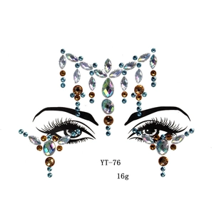 Macro shot of YT-76 iridescent blue and gold adhesive face gems for eye makeup