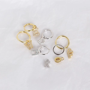 Macro detail of S925 sterling silver letter charms with sparkling pavé cubic zirconia