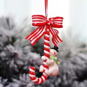 Christmas decoration featuring a snowman on a candy cane with a red bow for tree decor