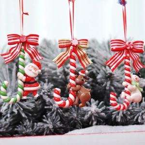 Detailed view of polymer clay Santa, reindeer, and snowman on candy canes for Christmas trees