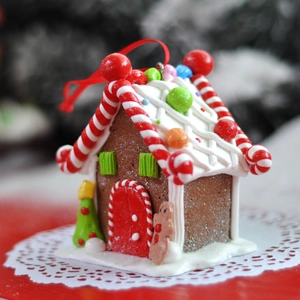 Christmas gingerbread house ornament with red ribbon hanger for festive home decoration