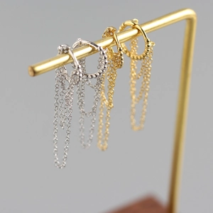 Detailed close-up of S925 sterling silver hoop earrings with bead decor and long chain tassels