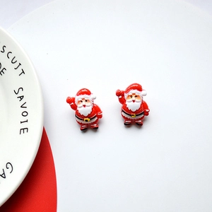 Close-up of dual Christmas Santa Claus resin earrings with red and white festive details
