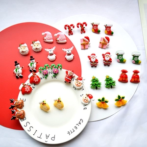 Detailed flat lay of festive handmade Christmas earrings set with snowman and reindeer