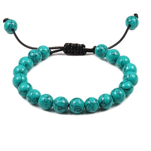 Detail of blue turquoise beaded bracelet with black veins and adjustable woven cord