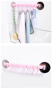 Pink kitchen wall hook rack with 6 hooks for towels and brushes in a bathroom setting
