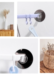 Detail of wall-mounted multi-hook rack showing adhesive backing and sliding hook system
