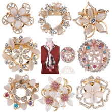 Detailed set of crystal swan and floral brooches showing golden rhinestones and opal details