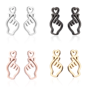 Set of four minimalist heart gesture stud earrings in silver, black, rose gold, and gold