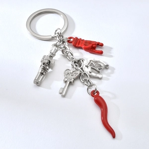 Silver keychain with red pepper, lucky horseshoe, heart and mano cornuta charms