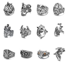 Collection of vintage silver-style rings with lion skull and floral designs in a 3x4 grid