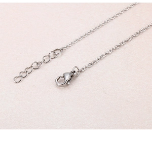 Detail of the lobster clasp and adjustable extension chain on the silver steel bracelet