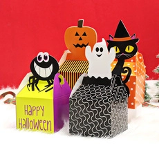 Set of four colorful Halloween gift boxes featuring pumpkin and ghost theme patterns