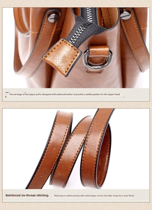 Close-up of brown leather bag showing reinforced stitching and premium metal zipper detail